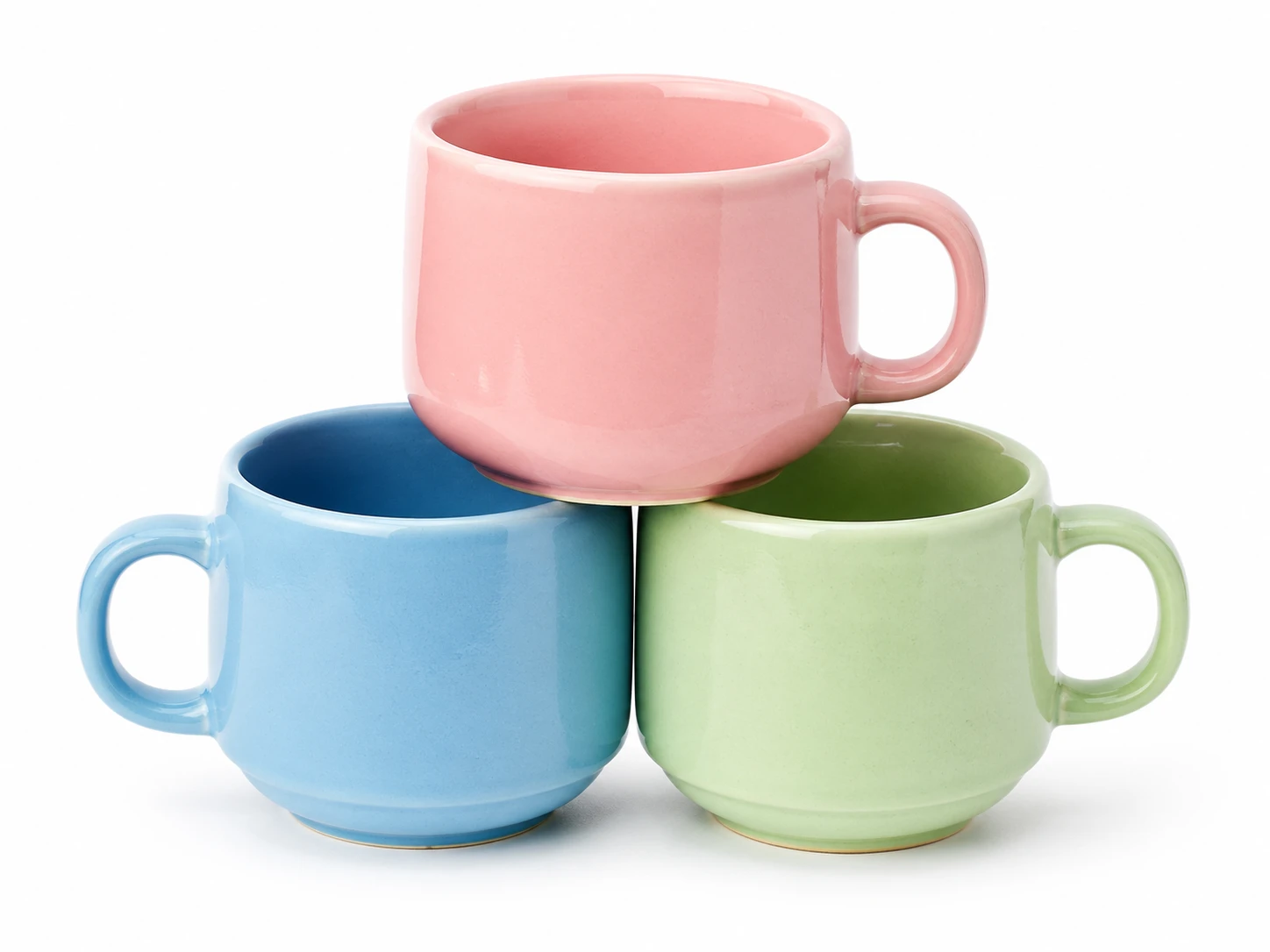 White background studio shot of a set of three ceramic stacking mugs in pastel blue, pink, and mint green, arranged in a playful pyramid, natural soft — GPT Image 2